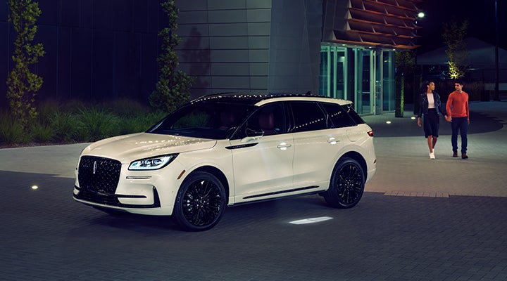 Two people approach a 2024 Lincoln Corsair® SUV featuring the available Jet Appearance Package. | Doral Lincoln in Doral FL