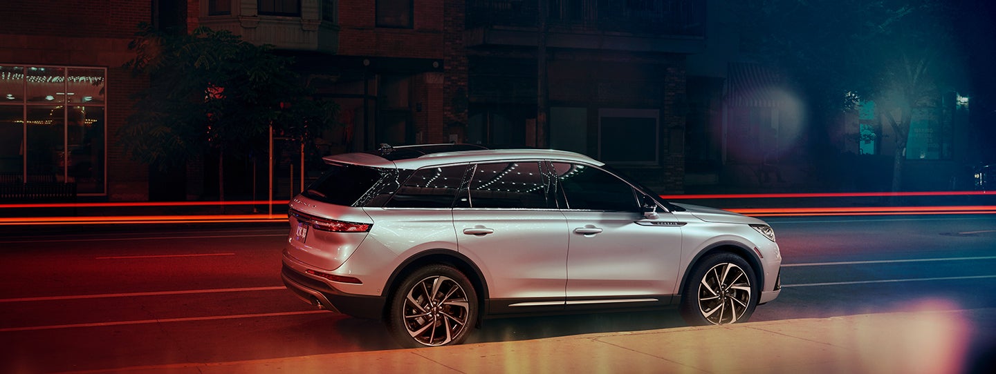 The 2024 Lincoln Corsair® SUV is parked on a city street at night. | Doral Lincoln in Doral FL