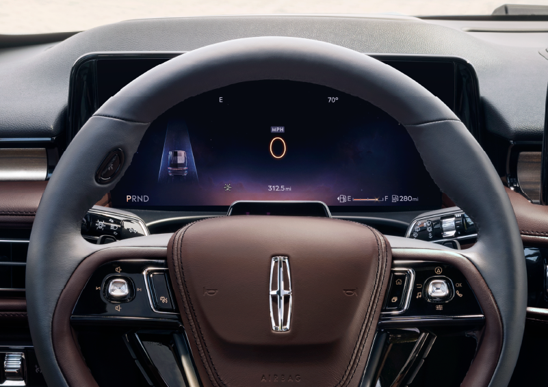 The steering wheel of 2025 Lincoln Aviator® SUV is shown with black and brown accents. | Doral Lincoln in Doral FL