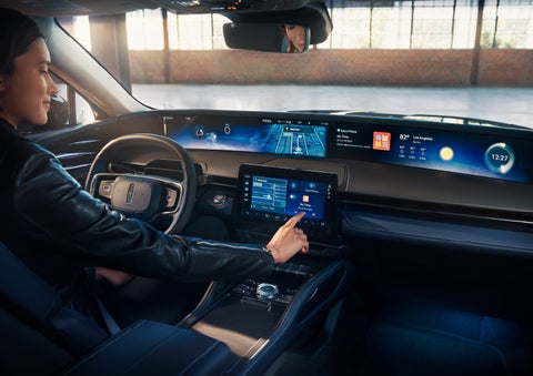 The driver of a 2025 Lincoln Nautilus® SUV interacts with the center touchscreen. | Doral Lincoln in Doral FL